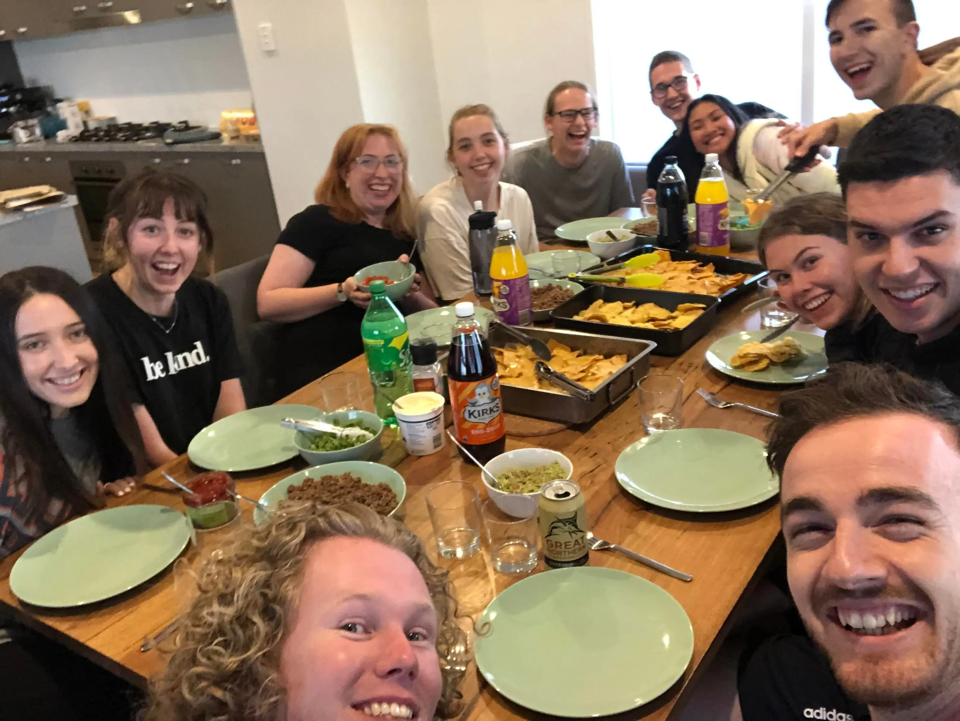 photo of people sitting around a table eating together